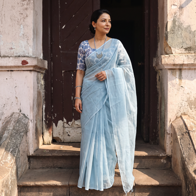 Blue Nazaakat Kota Doria Cotton Plain Saree with Blouse & Jewellery Set, draped and worn by a woman, AI visual of the saree, iTokri