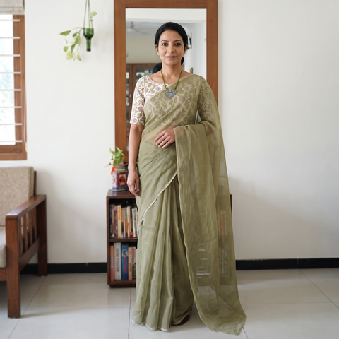 Green Nazaakat Kota Doria Cotton Plain Saree with Blouse & Jewellery Set, draped and worn by a woman, AI visual of the saree, iTokri