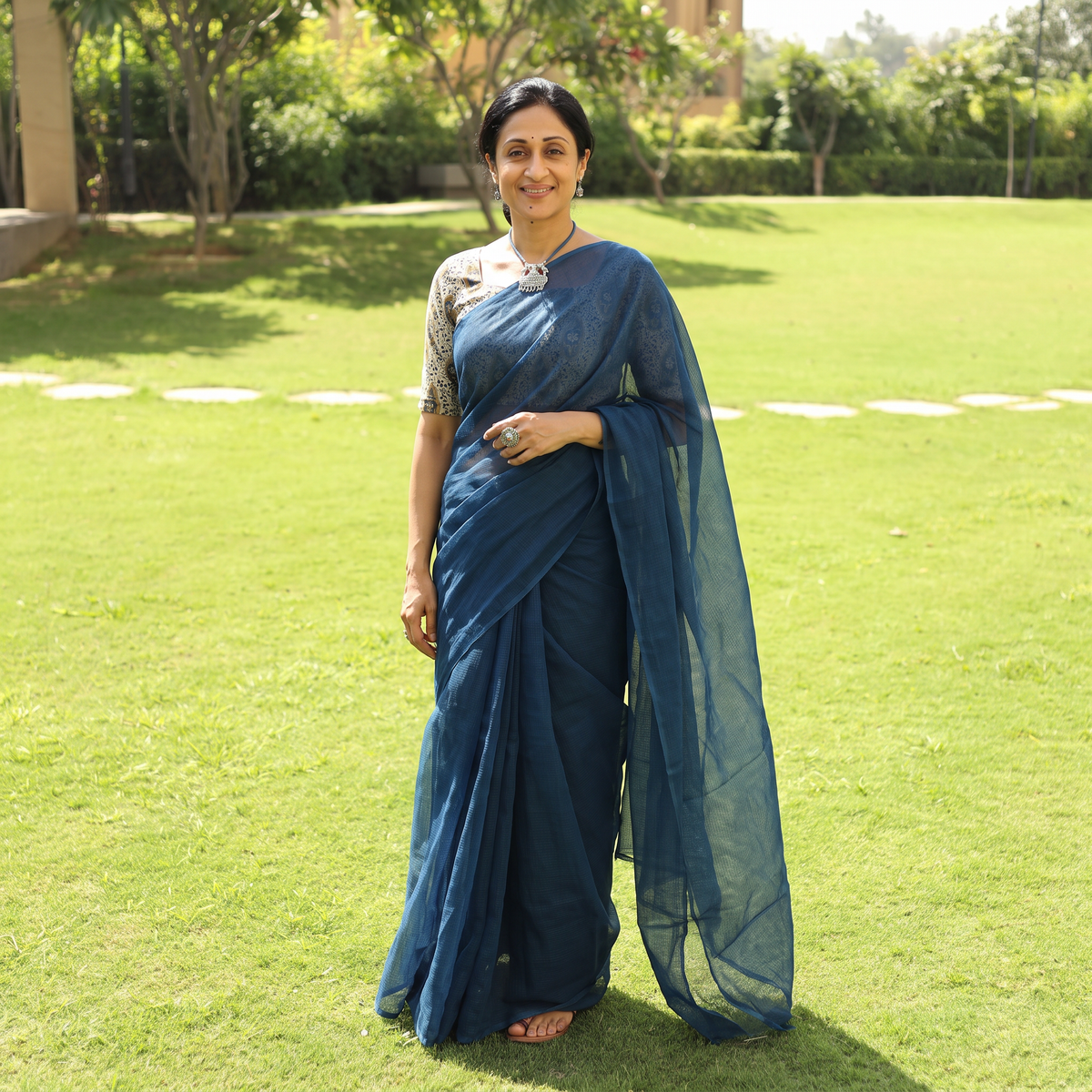 Blue Nazaakat Kota Doria Cotton Plain Saree with Blouse & Jewellery Set, draped and worn by a woman, AI visual of the saree, iTokri