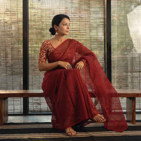 Maroon Nazaakat Kota Doria Cotton Plain Saree with Blouse Piece & Earrings, draped and worn by a woman, AI visual of the saree, iTokri