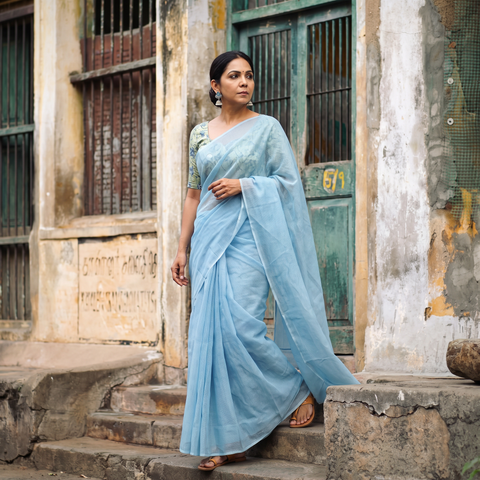 Blue Nazaakat Kota Doria Cotton Plain Saree with Blouse Piece & Earrings, draped and worn by a woman, AI visual of the saree, iTokri