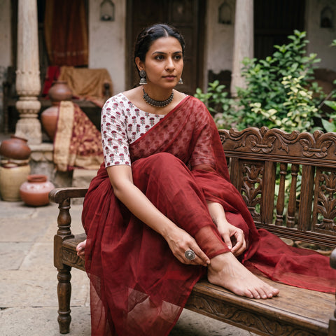 Maroon Nazaakat Kota Doria Cotton Plain Saree with Blouse Piece & Earrings, draped and worn by a woman, AI visual of the saree, iTokri