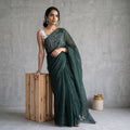 Green Nazaakat Kota Doria Cotton Plain Saree with Blouse Piece & Earrings, draped and worn by a woman, AI visual of the saree, iTokri