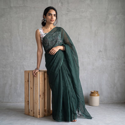 Green Nazaakat Kota Doria Cotton Plain Saree with Blouse Piece & Earrings, draped and worn by a woman, AI visual of the saree, iTokri