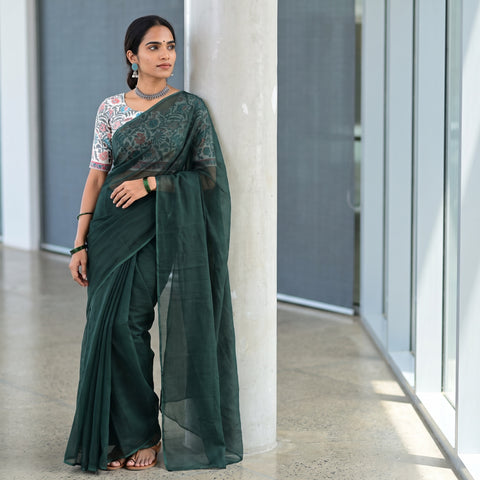 Green Nazaakat Kota Doria Cotton Plain Saree with Blouse Piece & Earrings, draped and worn by a woman, AI visual of the saree, iTokri