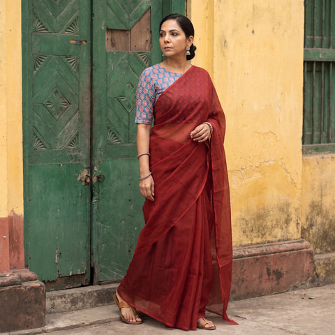 Maroon Nazaakat Kota Doria Cotton Plain Saree with Blouse Piece & Earrings, draped and worn by a woman, AI visual of the saree, iTokri
