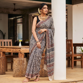 Black Pedana Block Print Cotton Kalamkari Saree, draped and worn by a woman, AI visual of the saree, iTokri