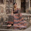 Black Pedana Hand Block Print Natural Dyed Cotton Kalamkari Saree, draped and worn by a woman, AI visual of the saree, iTokri