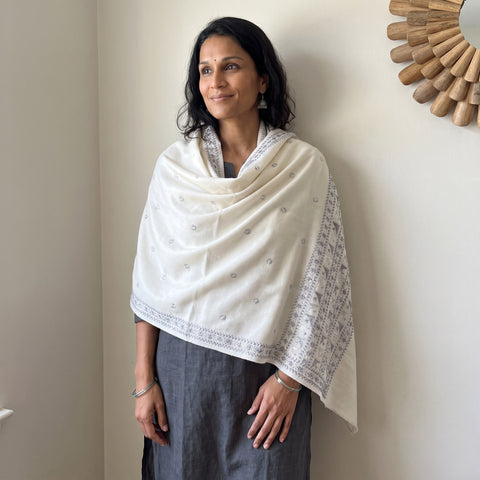 White Phulkari Hand Embroidered Wool Shawl, worn by a model, AI visual of the shawl, iTokri