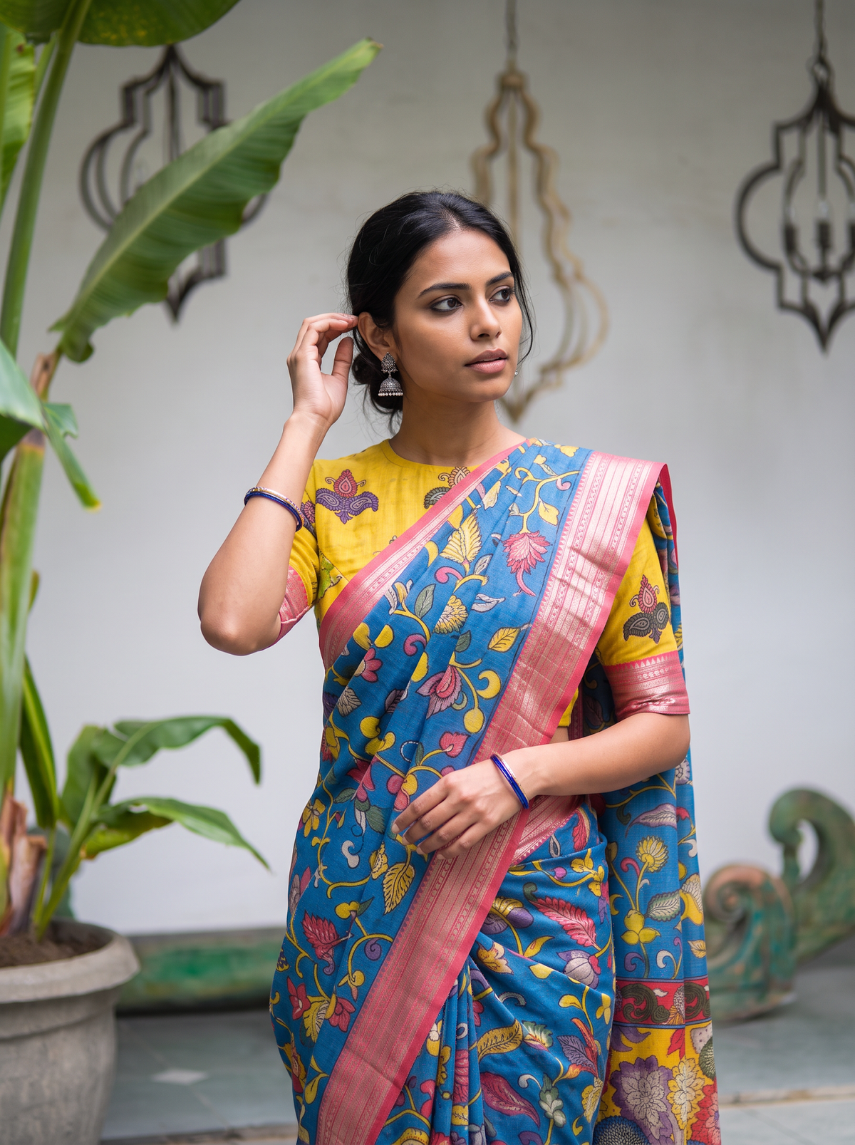 Closer front view of the vine-covered blue body and pink striped border at the shoulder, AI visual of the saree, iTokri