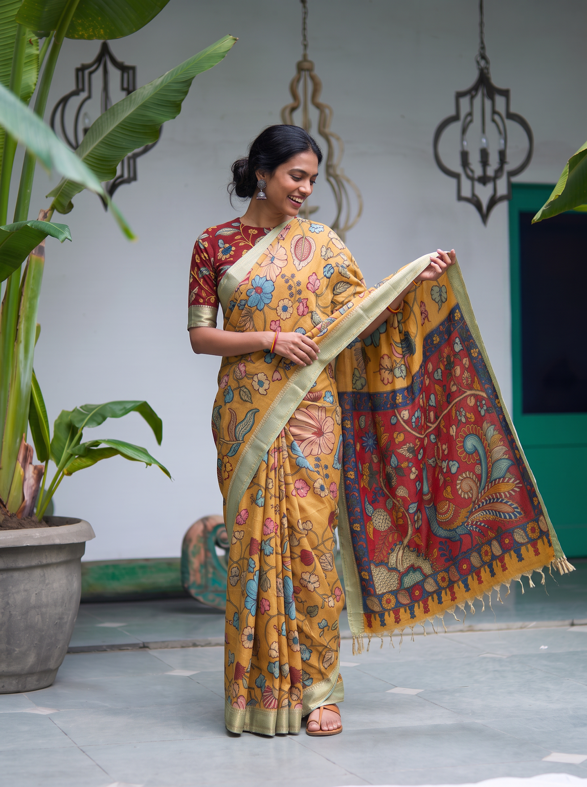 Red peacock pallu of the mustard Kalamkari saree opened out in both hands, AI visual of the saree, iTokri