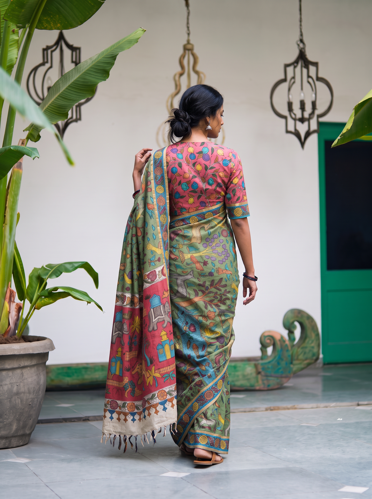 Back view with the coral pallu falling over the sage green body, AI visual of the saree, iTokri