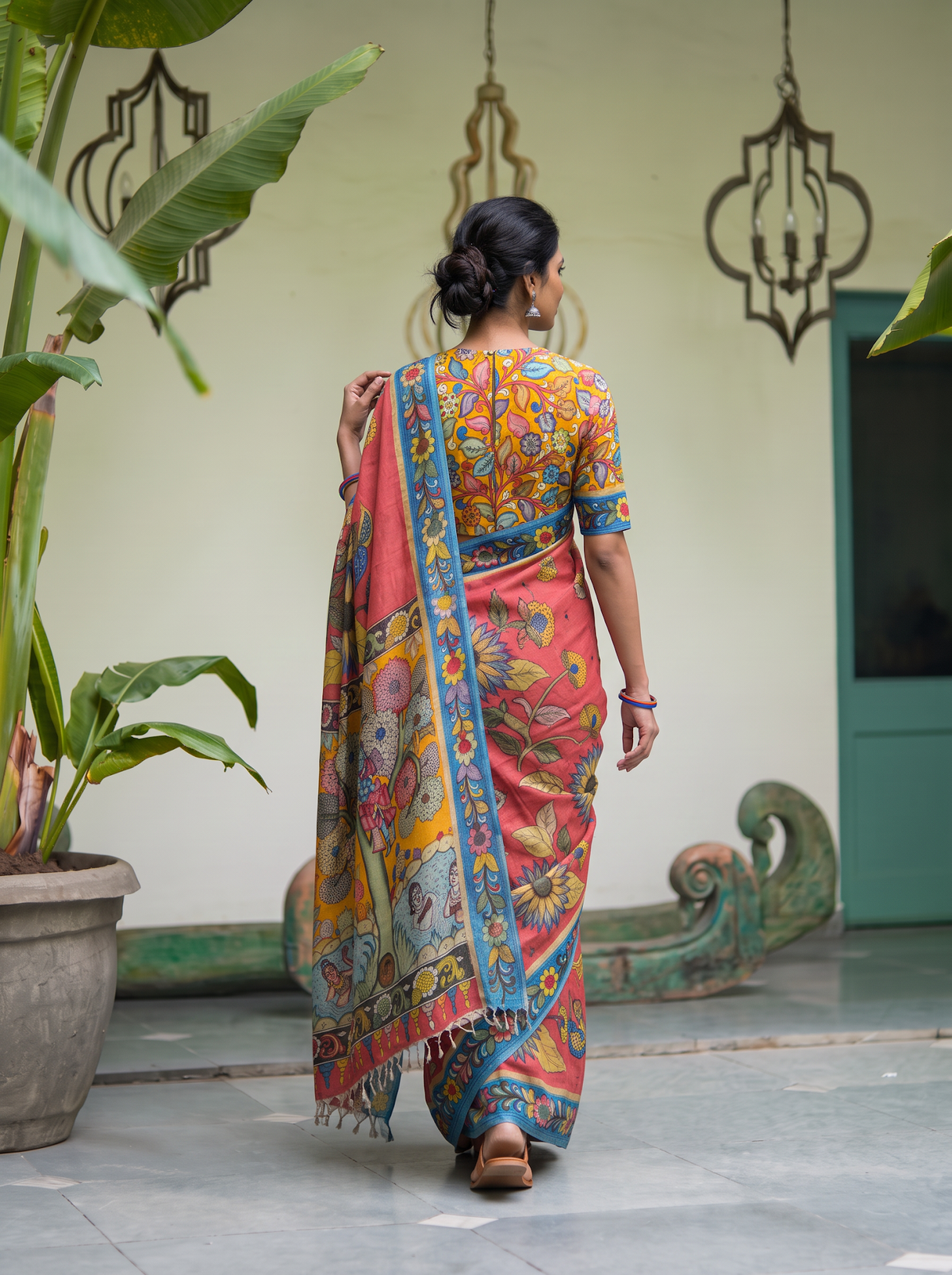 Back view with the mustard pallu falling over the coral pink body, AI visual of the saree, iTokri