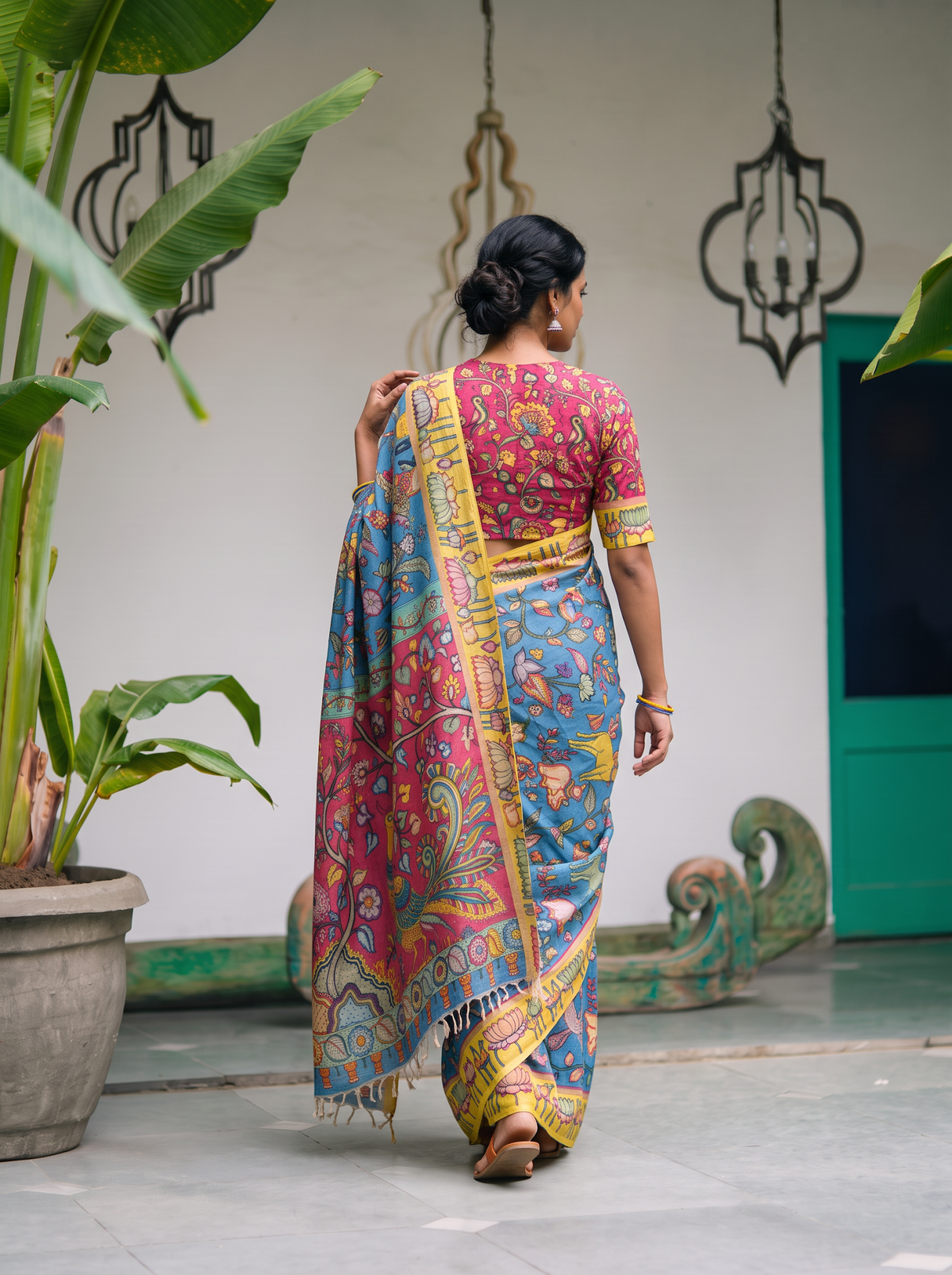 Back view with the magenta pallu hanging down over the blue body, AI visual of the saree, iTokri
