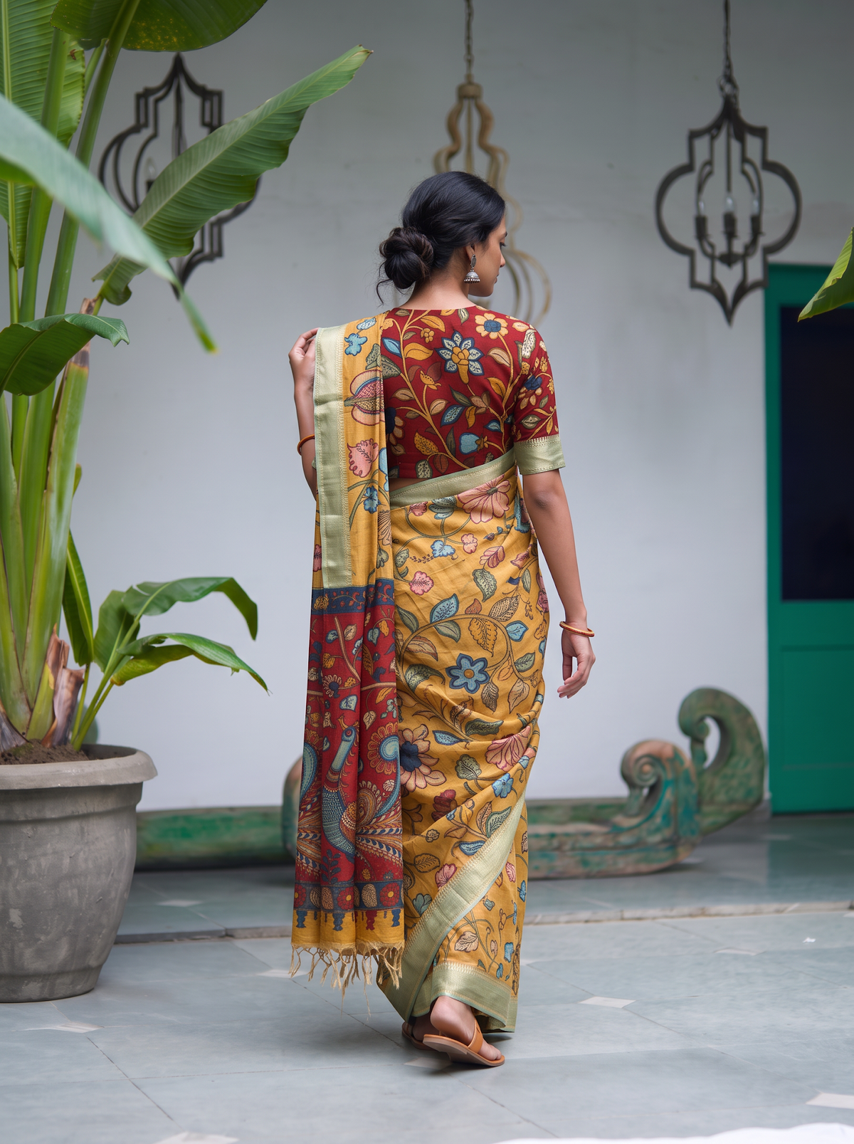 Back view of the mustard pen Kalamkari saree with the red pallu falling behind, AI visual of the saree, iTokri