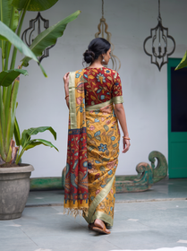 Back view of the mustard pen Kalamkari saree with the red pallu falling behind, AI visual of the saree, iTokri