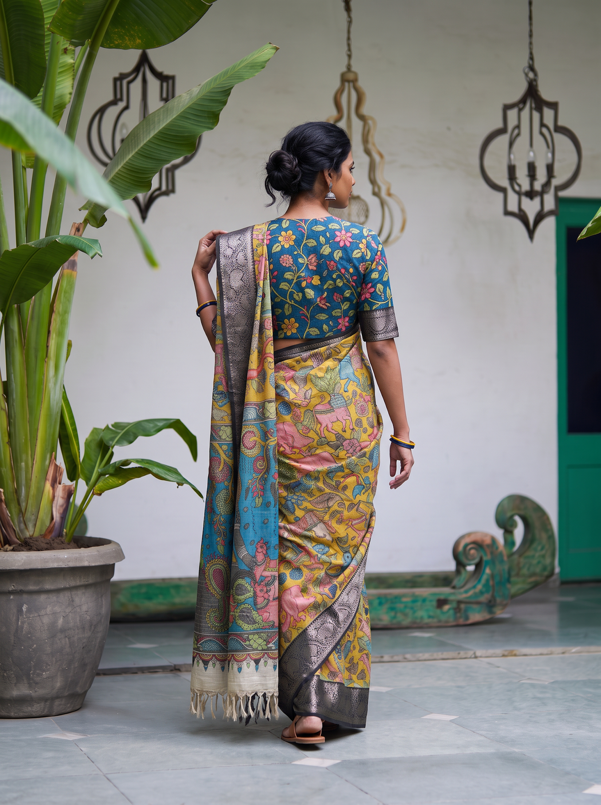Back view of the mustard yellow pen Kalamkari saree with the teal pallu over the shoulder, AI visual of the saree, iTokri