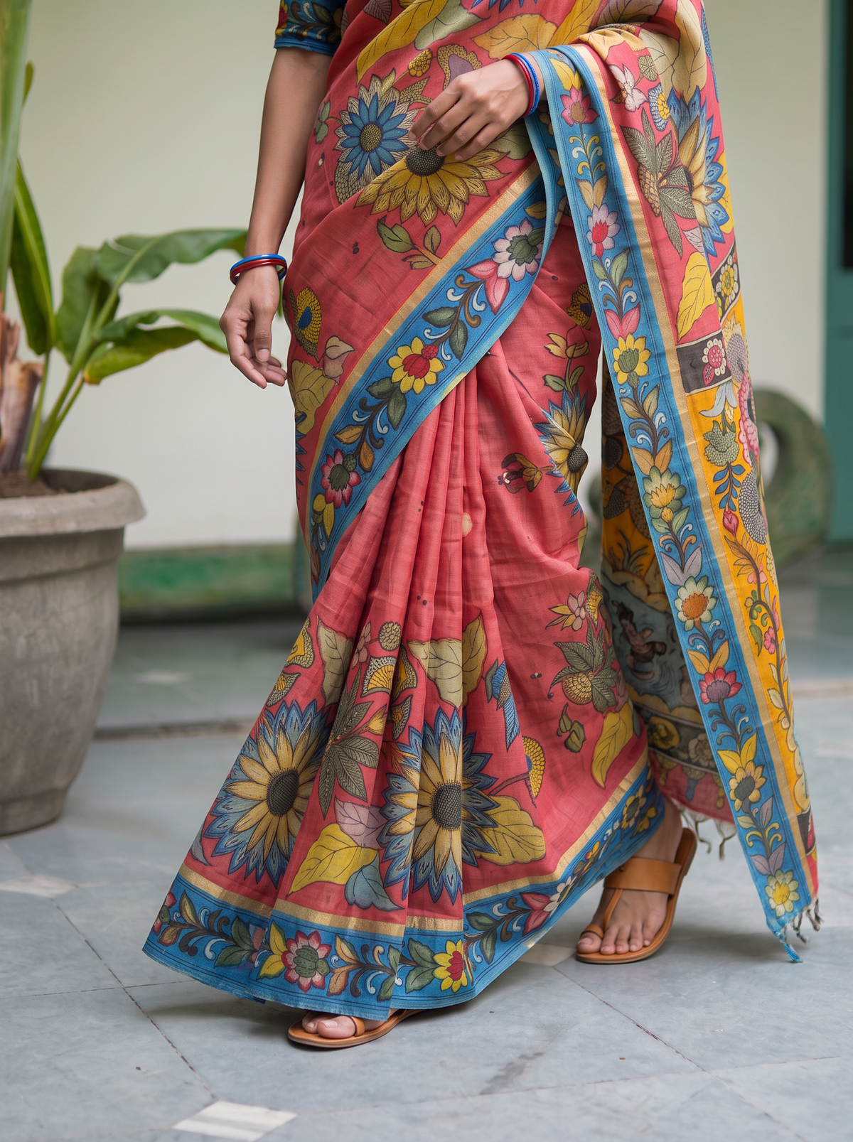 Pleats with large sunflowers and a blue vine hem on coral pink, AI visual of the saree, iTokri