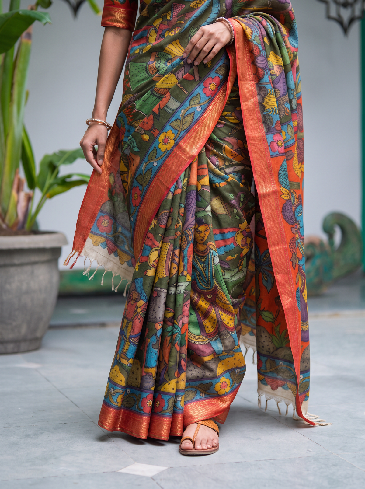 Pleats of the green silk cotton Kalamkari saree with painted figures and tassels, AI visual of the saree, iTokri