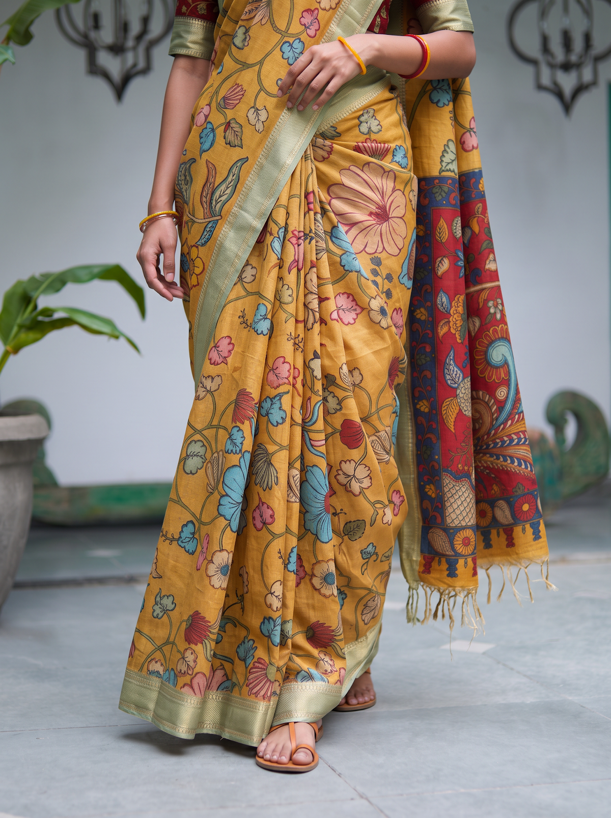 Pleats of the mustard silk cotton Kalamkari saree with the pale gold border, AI visual of the saree, iTokri
