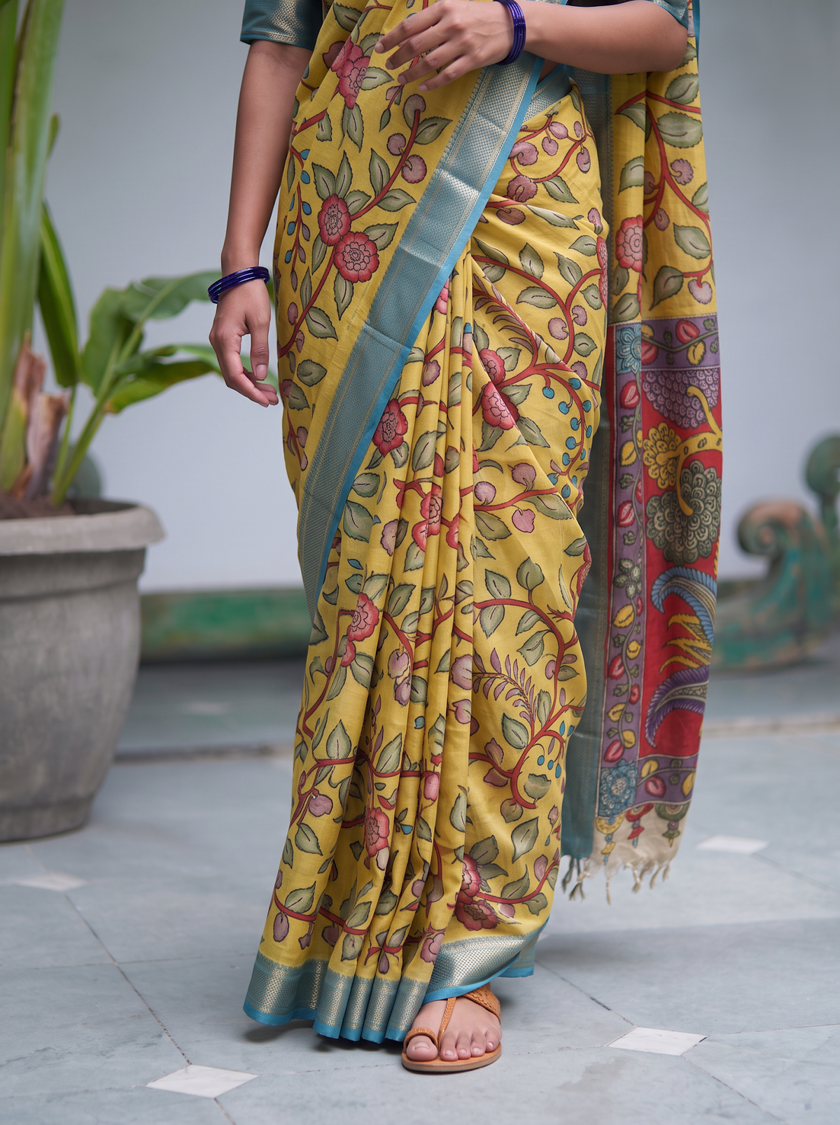 Pleats of the yellow silk cotton Kalamkari saree, sky blue silver border, AI visual of the saree, iTokri