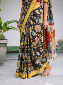 Pleats of the black body with pastel flowers above a mustard yellow hem, AI visual of the saree, iTokri