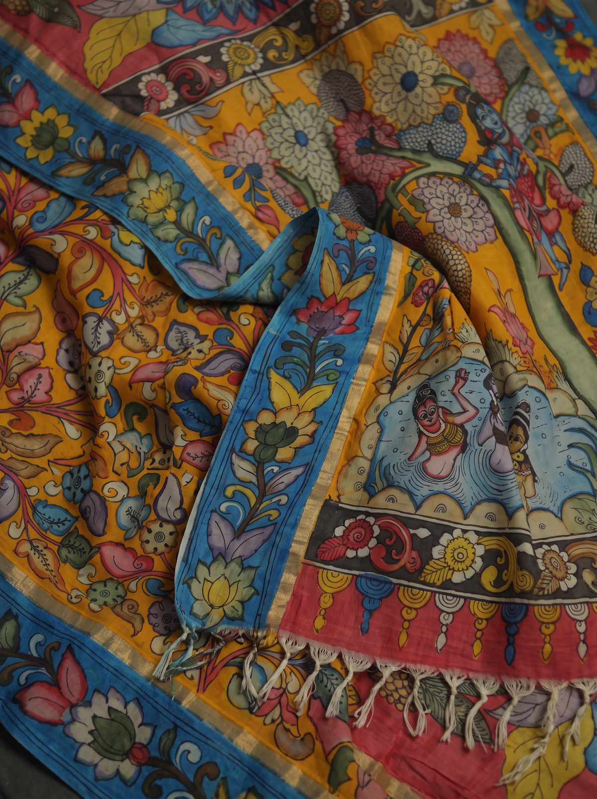 Detail of the tree and bathing figures on the mustard pallu, with blue vines and fringe, AI visual of the saree, iTokri