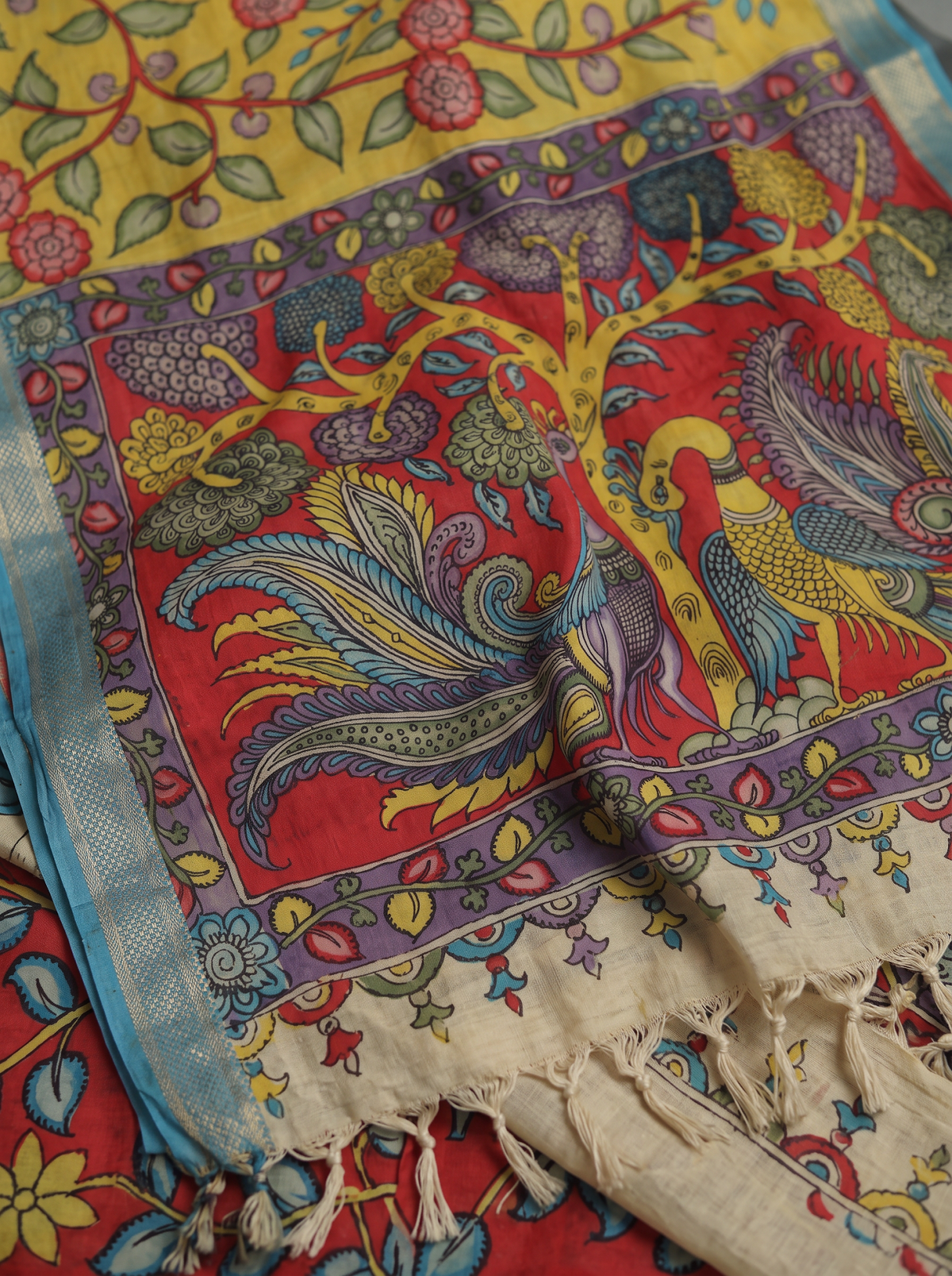 Two peacocks under a tree on the red pallu, sky blue border and fringe, detail, AI visual of the saree, iTokri