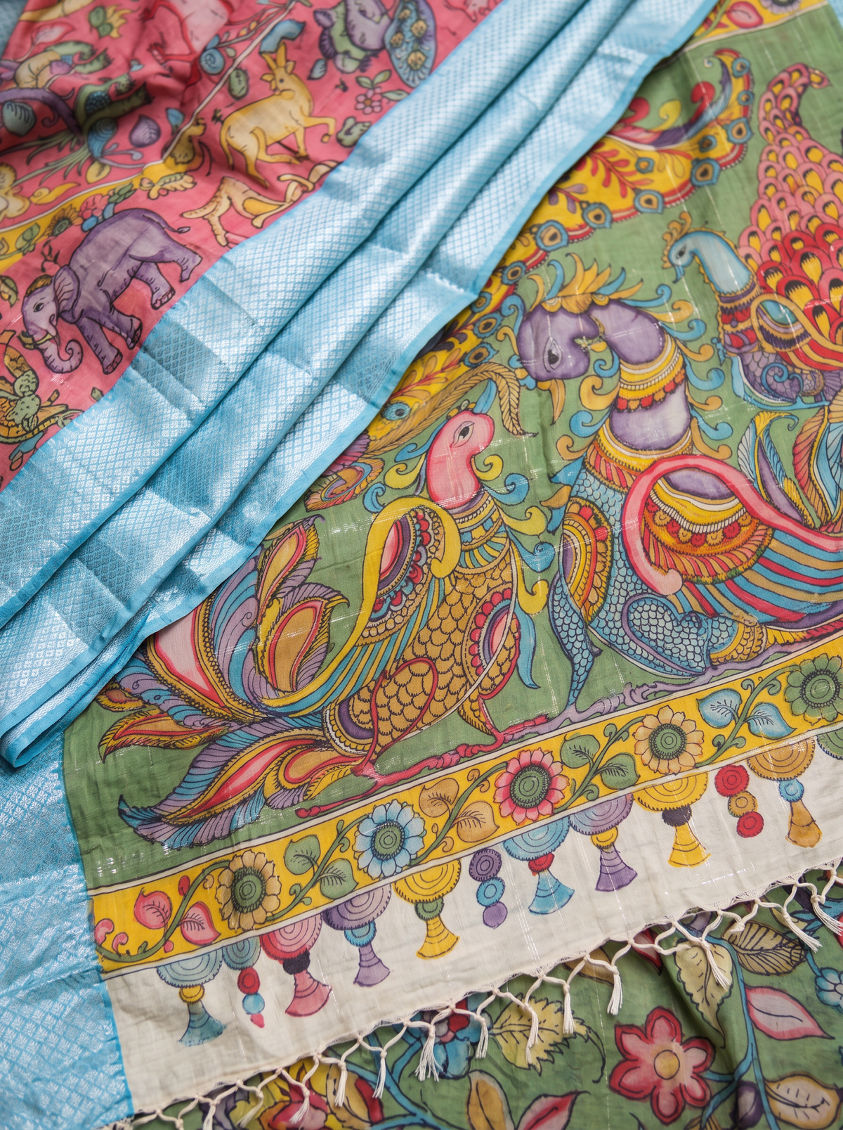 Detail of curling birds on the green pallu beside the silvery blue lattice border, AI visual of the saree, iTokri