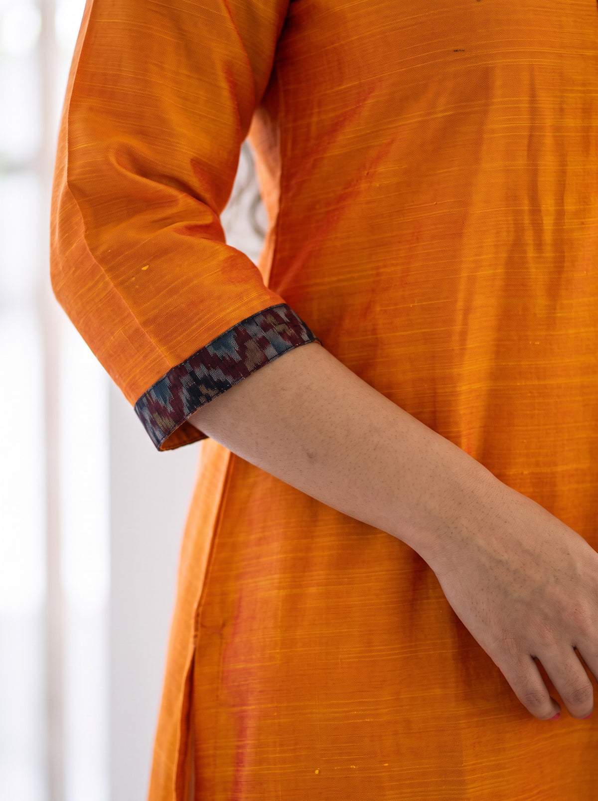 Orange Plain Art Silk Patterned Neck Band Kurta, sleeve close-up, 3/4 banded sleeves, 7 buttons, slits, AI visual of the kurta, iTokri