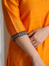 Orange Plain Art Silk Sequin Trim Kurta, sleeve close-up, 3/4 sleeves, black-gold zig-zag sequin trim, AI visual of the kurta, iTokri