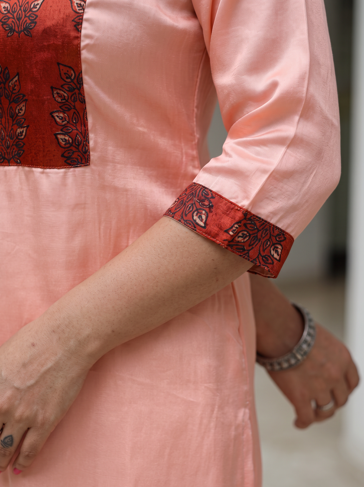 Peach Plain Modal Silk Rust Yoke Kurta, sleeve close-up, 3/4 sleeves, rust cuffs, slits, pulls on, AI visual of the kurta, iTokri