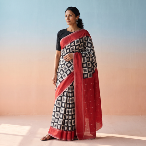 Black Pochampally Ikat Weave Handloom Cotton Saree, draped and worn by a woman, AI visual of the saree, iTokri
