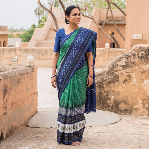 Green Pochampally Ikat Weave Pure Handloom Cotton Saree, draped and worn by a woman, AI visual of the saree, iTokri
