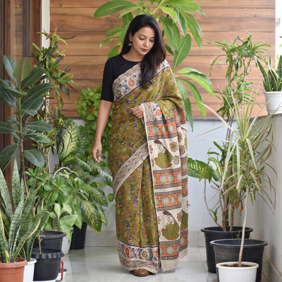 Green Printed Cotton Kalamkari Saree with Blouse Piece, draped and worn by a woman, AI visual of the saree, iTokri