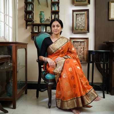 Orange Pure Cotton Handloom Bengal Tant Saree with Zari & Thread Work, draped and worn by a woman, AI visual of the saree, iTokri