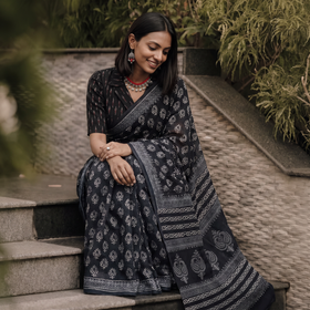 Black pure mul cotton hand block Sanganeri print saree, draped and worn by a woman, AI visual of the saree, iTokri