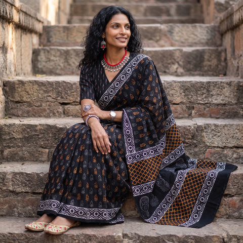 Black pure mul cotton hand block Sanganeri print saree, draped and worn by a woman, AI visual of the saree, iTokri