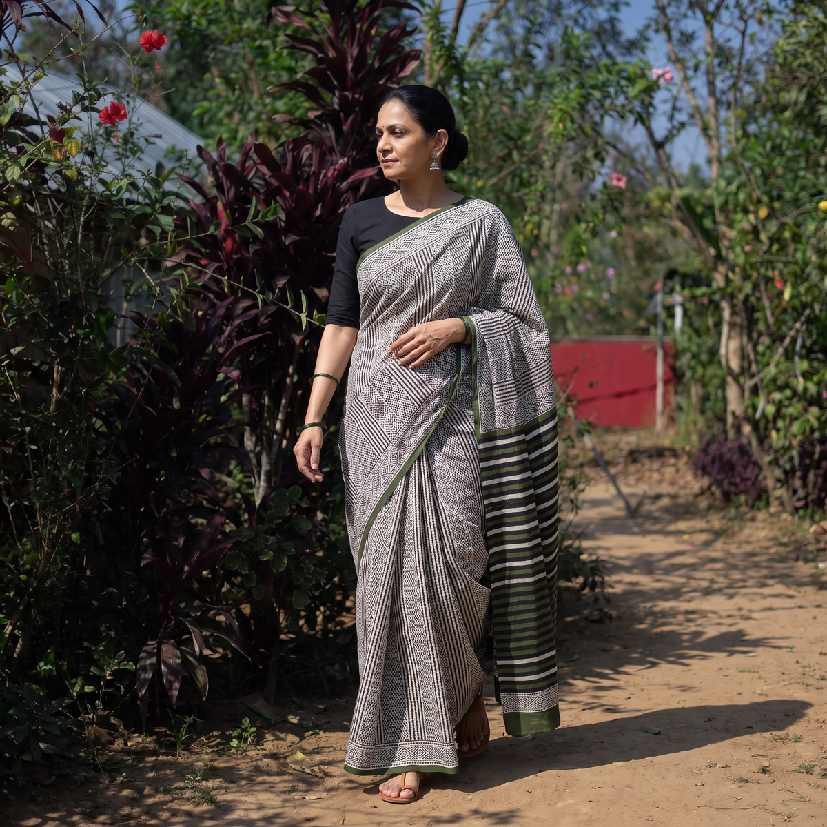 Black Pure Mul Cotton Natural Dyed Hand Block Dabu Bagru Print Saree, draped and worn by a woman, AI visual of the saree, iTokri