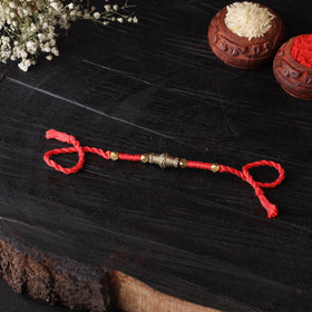 Handcrafted tribal dokra brass thread rakhi 20