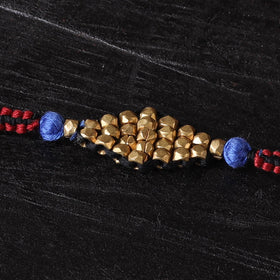 Handcrafted tribal dokra brass thread rakhi 44