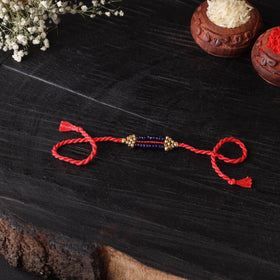Handcrafted tribal dokra brass thread rakhi 52