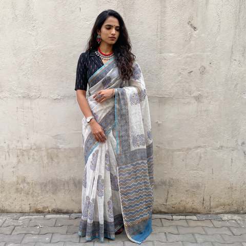 White and grey Sanganeri hand block print Kota Doria cotton saree by artisan Purushottam Chhipa, draped and worn by a woman, AI visual of the saree, iTokri