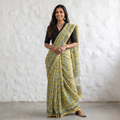 Yellow Sanganeri hand block print Kota Doria cotton saree by artisan Purushottam Chhipa, draped and worn by a woman, AI visual of the saree, iTokri