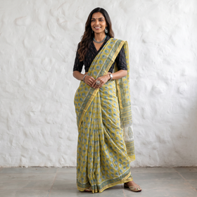 Yellow Sanganeri hand block print Kota Doria cotton saree by artisan Purushottam Chhipa, draped and worn by a woman, AI visual of the saree, iTokri