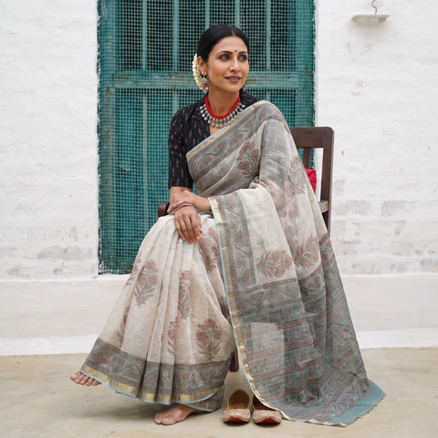Off white and grey Sanganeri hand block print Kota Doria cotton saree by artisan Purushottam Chhipa, draped and worn by a woman, AI visual of the saree, iTokri