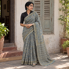 Grey blue Sanganeri hand block print Kota Doria cotton saree by artisan Purushottam Chhipa, draped and worn by a woman, AI visual of the saree, iTokri