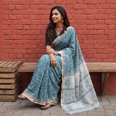 Teal blue Sanganeri hand block print Kota Doria cotton saree by artisan Purushottam Chhipa, draped and worn by a woman, AI visual of the saree, iTokri