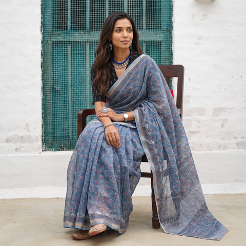Blue grey Sanganeri hand block print Kota Doria cotton saree by artisan Purushottam Chhipa, draped and worn by a woman, AI visual of the saree, iTokri