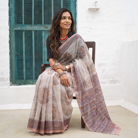 Off white and pink Sanganeri hand block print Kota Doria cotton saree by artisan Purushottam Chhipa, draped and worn by a woman, AI visual of the saree, iTokri